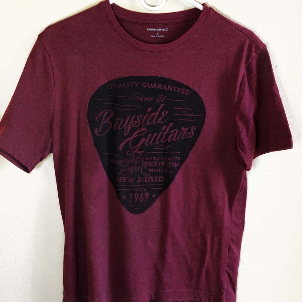 maroon graphic tee with guitar pick